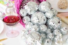 a hot pink cornucopia with disco balls instead of veggies is a fantastic glam decor idea