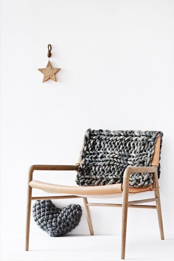 a leather chair with a pretty chunky knit cover and a chunky knit heart are a lovely idea for a modern space