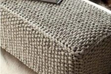 a long grey knit ottoman with vintage legs is a cool piece to cozy up your room and make it welcoming