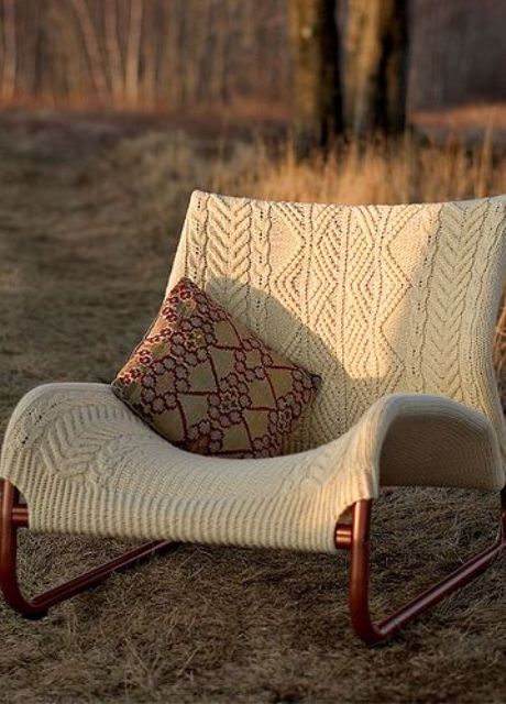a lounger covered with a neutral patterned piece is a great way to style a chair for the cold season