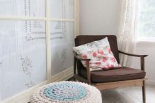a mid-century modenr ottoman with a pastel crochet cover is a nice idea to add a soft touch of color and coziness