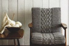 a mid-century modern chair finished off with cozy grey knit is a lovely idea to make your space welcoming