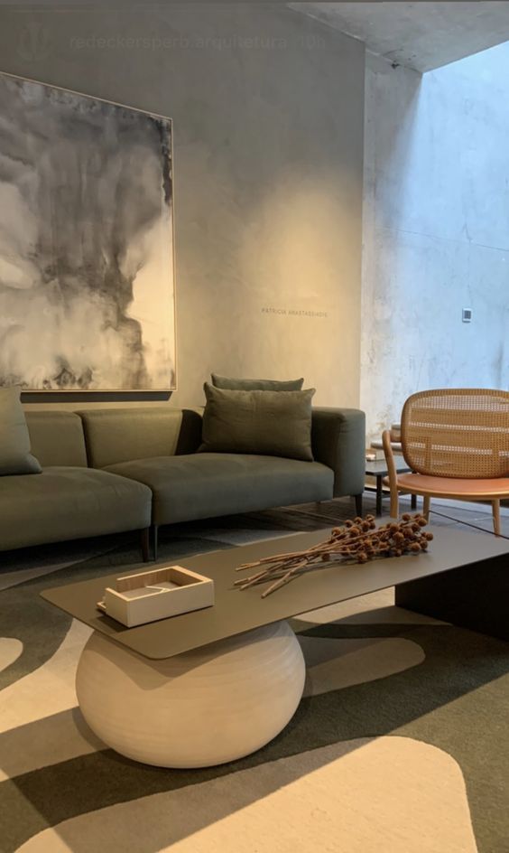 a modern coffee table with a plaster ball and a black waterfall tabletop is a catchy idea for a contrasting space