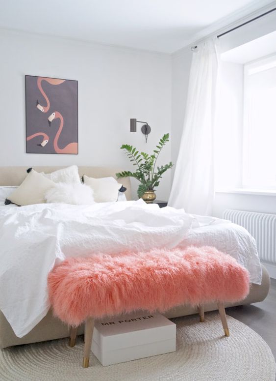 a pink faux fur bench adds color to the space and brings much texture to it making it more welcoming