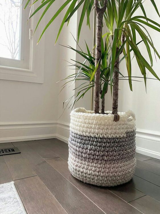 a planter covered with an ombre chunky crochet piece with handles is a great idea to rock for the fall or winter