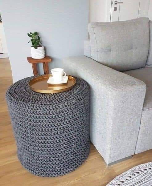 a pouf styled with a grey chunky knit cover is a lovely and cozy idea for a modern space, it brings texture and interest to the space