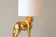 a quirky gold giraffe table lamp with a sleek lampshade will add a whimsical feel to your room and make it refined