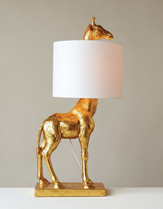 a quirky gold giraffe table lamp with a sleek lampshade will add a whimsical feel to your room and make it refined