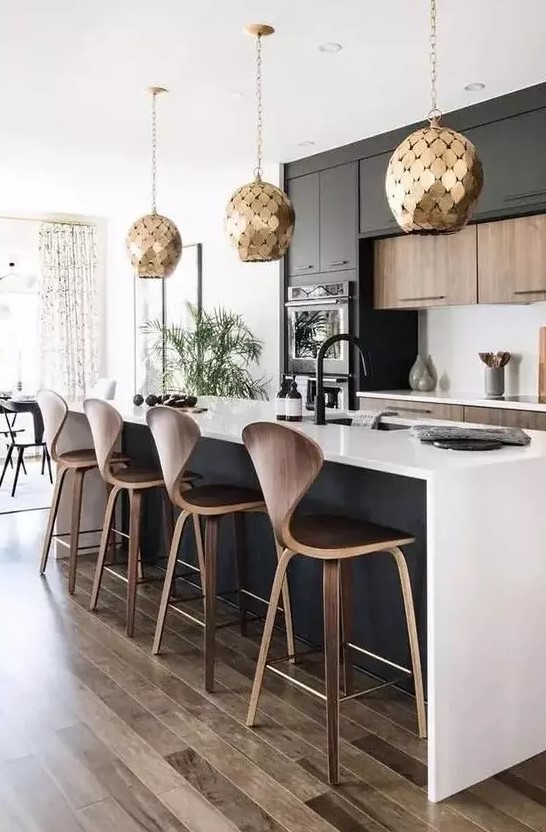 a stylish black and white contemporary kitchen with jaw-dropping gold scale pendant lamps is jaw-dropping