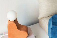 a unique terra cotta heart table lamp with a bulb on top is a creative and fun idea for a mid-century modern space