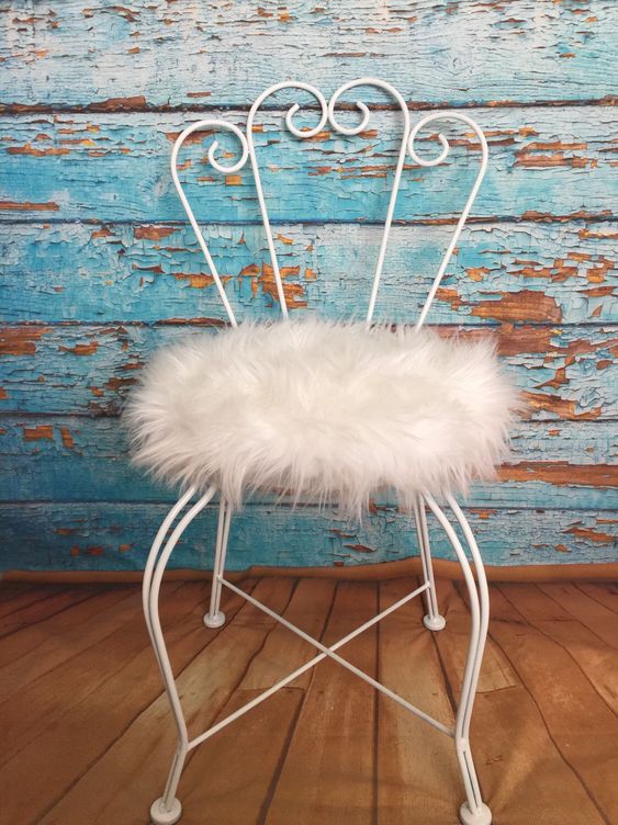 a vintage chair with a white faux fur seat is a nice solution for a glam or shabby chic space