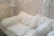 a white chunky knit sofa with matching pillows invites to relax and sleep on it