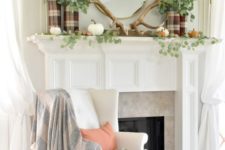 a woodland fall mantel with antlers, natural pumpkins, greenery and plaid vases
