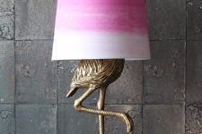 an antique bronze flamingo table lamp with a tie-dye pink lampshade for a touch of color to the space