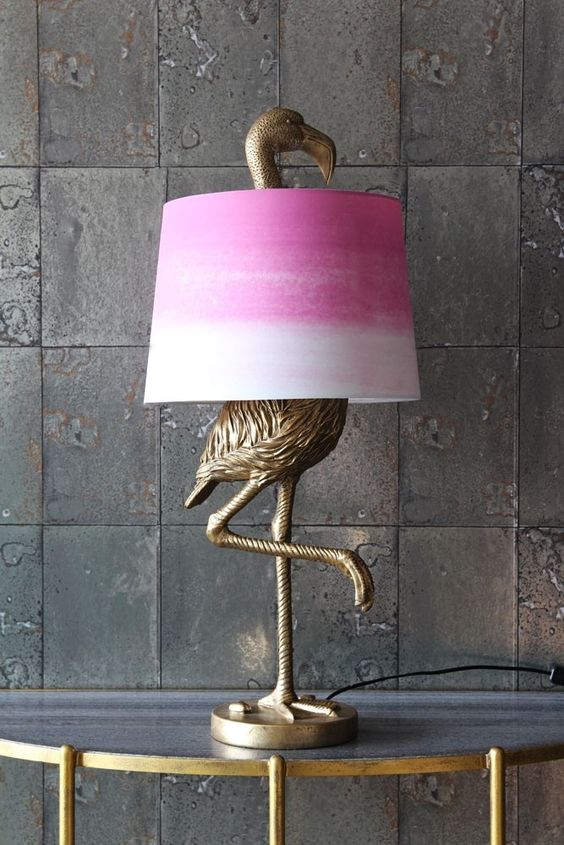 an antique bronze flamingo table lamp with a tie-dye pink lampshade for a touch of color to the space