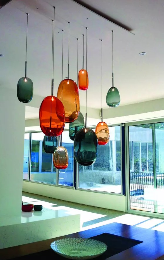 beautiful and mismatching glass bubble pendant lamps in orange and teal will make your kitchen colorful and unique