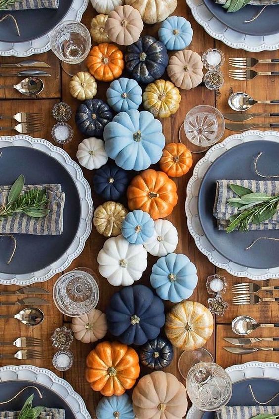 colorful painted pumpkins for a cool table runner, fresh twigs for each place setting and some candles