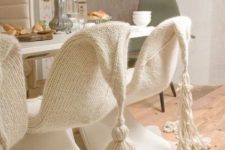 cover your usual dining chairs with white knit or crochet with large tassels to make them cute and very cozy for sitting