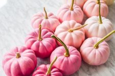 painted red, pink, blush and yellow pumpkins create a bold and cool fall centerpiece in unexpected colors