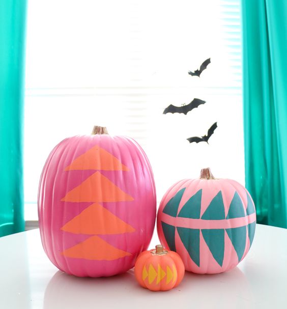 pink, orange and hot pink pumpkins with geometric stencils are a very bold and cool decoration