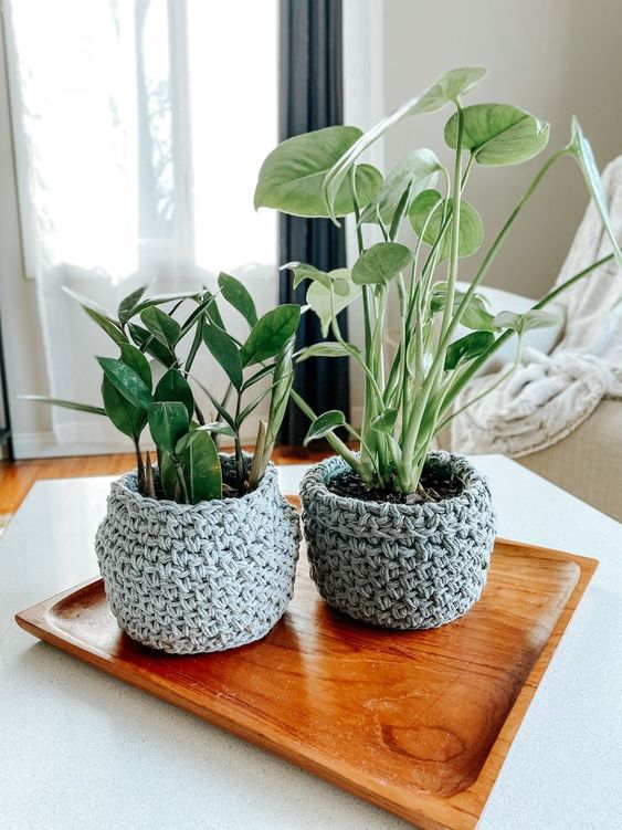 planters covered with grey chunky knit cozies are amazing to style them for the fall or winter or to renovate them and give them a cozy feel