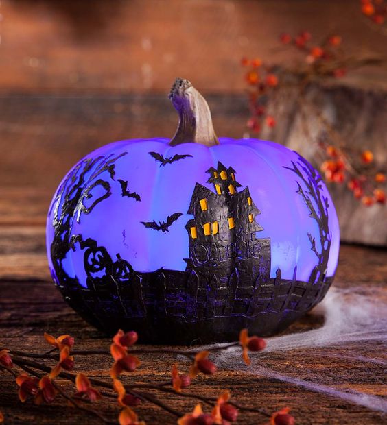 a beautiful painted purple pumpkin with a Halloween scene is a gorgeous decoration for Halloween
