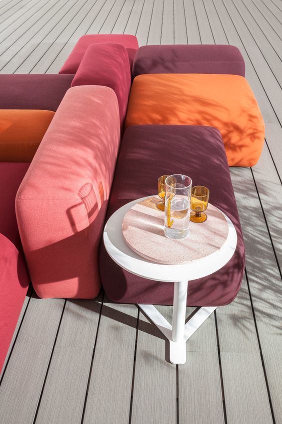 a colorful modular sofa in orange, purple and pink is a cool and fun idea for outdoors and can be used for indoors