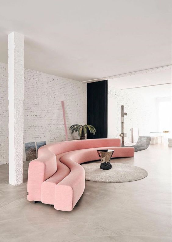a creative pink sofa of several curved beams is a unique solution for a contemporary space as curves are super actual