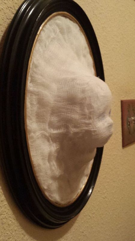 a ghost baby face frame picture is a bold solution for vintage Halloween decor and you can DIY it