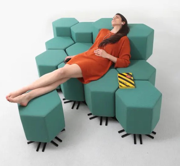 a green sofa composed of hexagon pieces attached to each other, with black legs, is a functional and practical idea for a modern space