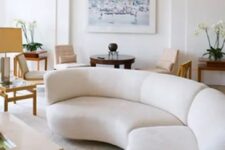 a long rounded creamy sectional sofa adds a whimsy touch to this contemporary space
