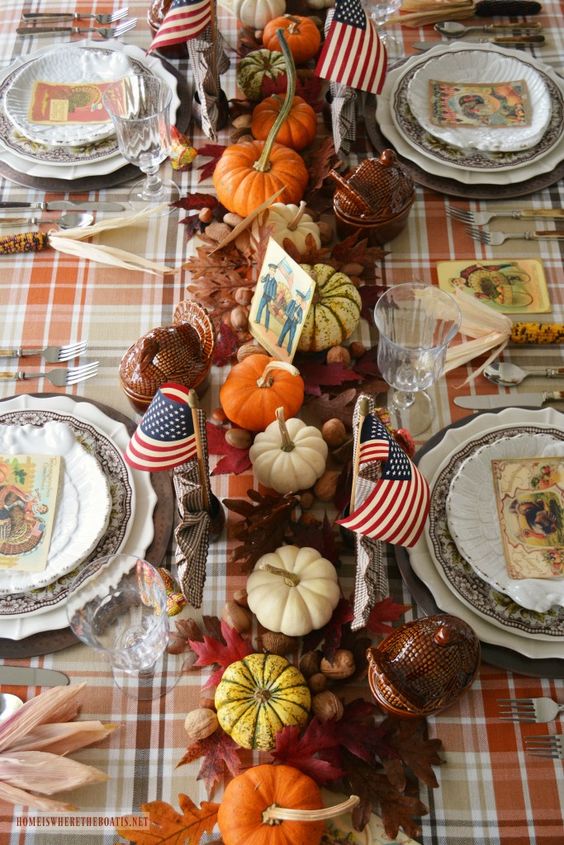 a refined vintage Thanksgiving tablescape with dried leaves, nuts, acorns, pumpkins, vintage porcelain and vintage cards