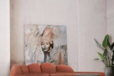 a rust-colored curved low sofa with a creative back and gold legs is a very chic and cool idea for a contemporary and refined space