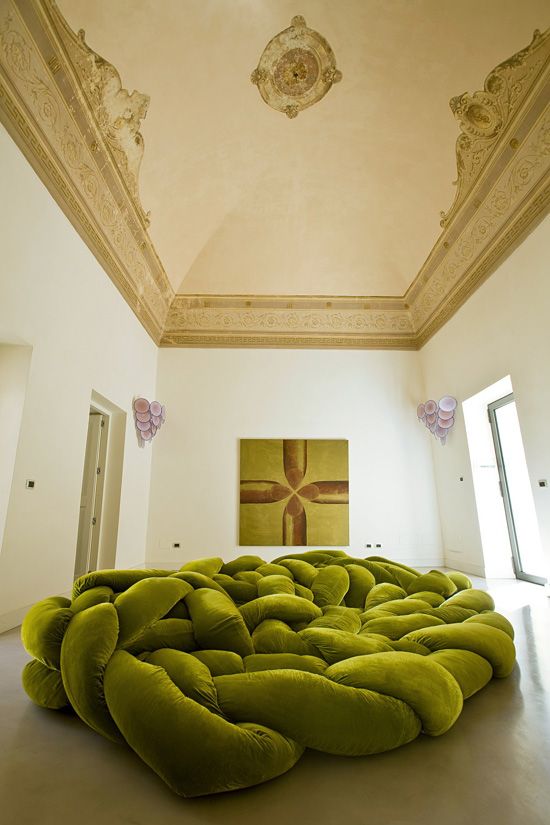a super creative green nest-inspried woven sofa welcomes and invites to lie on it and relax a lot