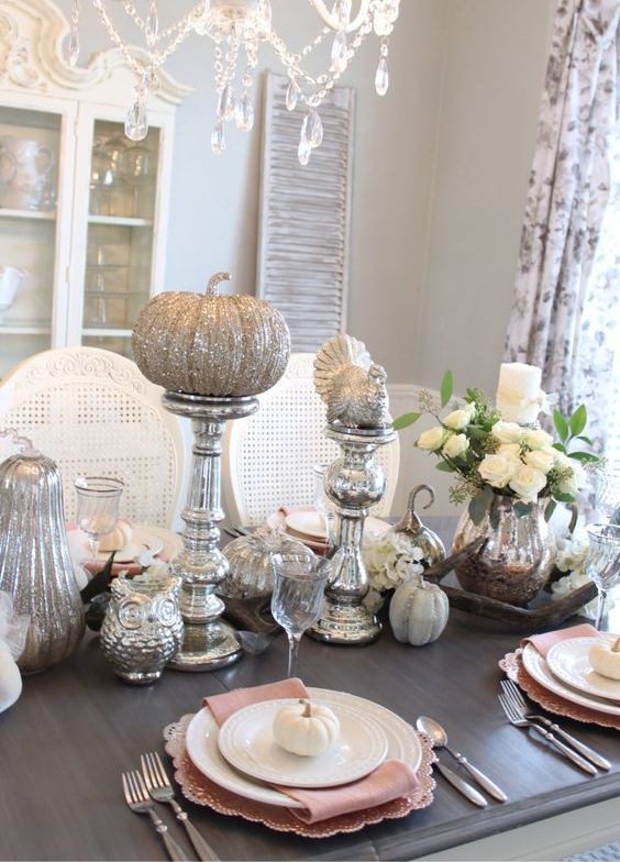 a vintage Thanksgiving table with mercury glass stands, silver glitter pumpkins, turkey, white blooms and pink and white porcelain