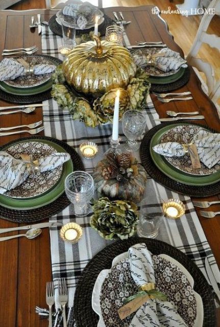 a vintage Thanksgiving tablescape with a plaid runner, green and floral plates, quote napkins,a gold pumpkin and candleholders