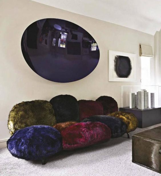 a whimsical dark colored faux fur sofa that seems to be composed of separate pompoms is a fantastic idea