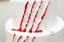 a white cake with scratches and bloody dirpping is a perfect solution for any kind of Halloween party