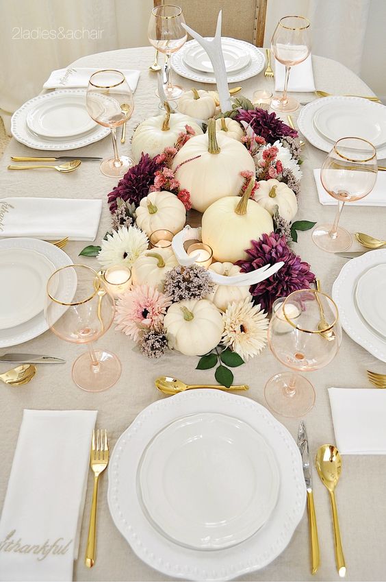 gold cutlery, gold rimmed glasses gold stemmed pumpkins for a modern refined Thanksgiving tablescape