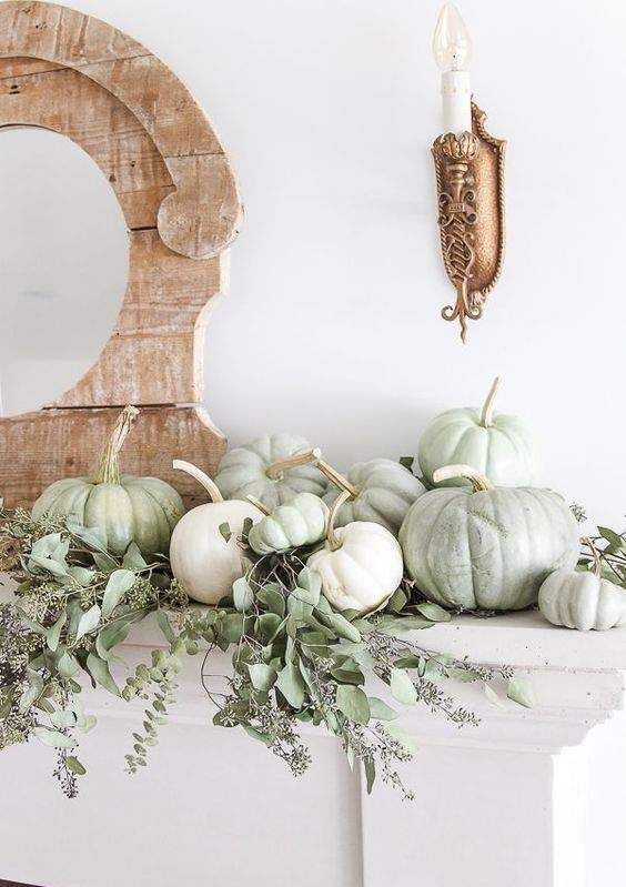 light green and white pumpkins plus greenery will beautifully decorate your mantel for Thanksgiving