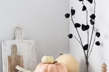 minimalist Halloween decor with black dried blooms on branches, neutral pumpkins is easy and very fresh and cool