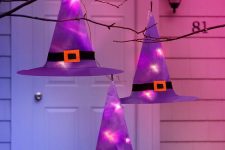 a cute outdoor Halloween decor with witches’ hats
