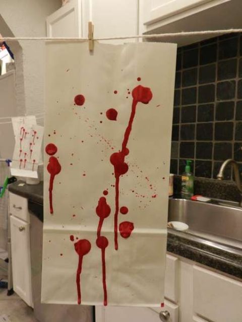 paper with bloody splatters and dripping is a cool and veyr eays way to style your space for a Dexter themed Halloween party