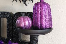 purple glitter pumpkins and purple feathers for elegant and shiny Halloween decor with touches of purple