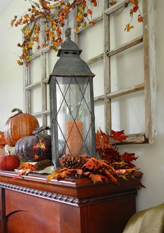 rustic vintage Thanksgiving decor of bright leaves, pinecones, pumpkins and dried leaves and berries over the table