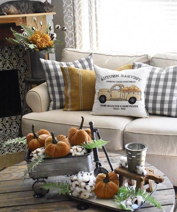 rustic vintage Thanksgiving decor of metal buckets, cotton, orange velvet pumpkins and greenery