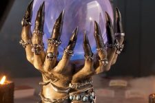 witch’s hands with lots of jewelry holding a magical ball that will tell the future is a great idea for Halloween