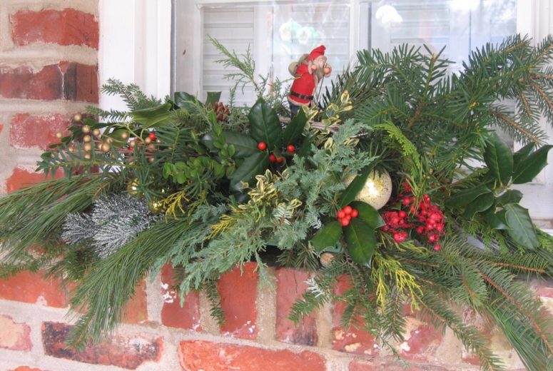 Make an outdoor window holiday swag using floral wire to fix things up.