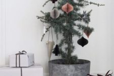 a Christmas tree in a metal pot with 3D paper ornaments is a stylish and chic idea
