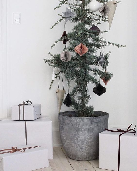 a Christmas tree in a metal pot with 3D paper ornaments is a stylish and chic idea